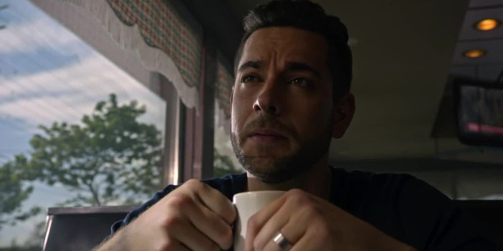 Cole holds a cup of coffee in a diner on Heroes Reborn