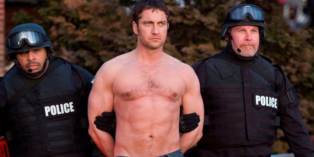A shirtless Clyde is detained by police in Law Abiding Citizen