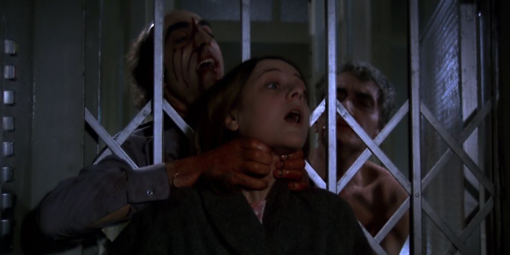 A woman is strangled by a zombie behind bars in Let Sleeping Corpses Lie
