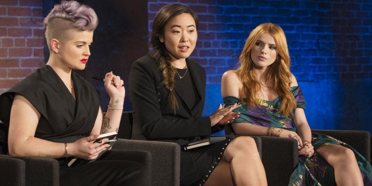 Bella Thorne looks over at Kelly Osbourne as a woman looks on in Project Runway.