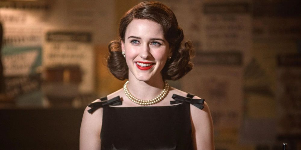 Midge wears a black dress with bows on shoulders in The Marvelous Mrs. Maisel