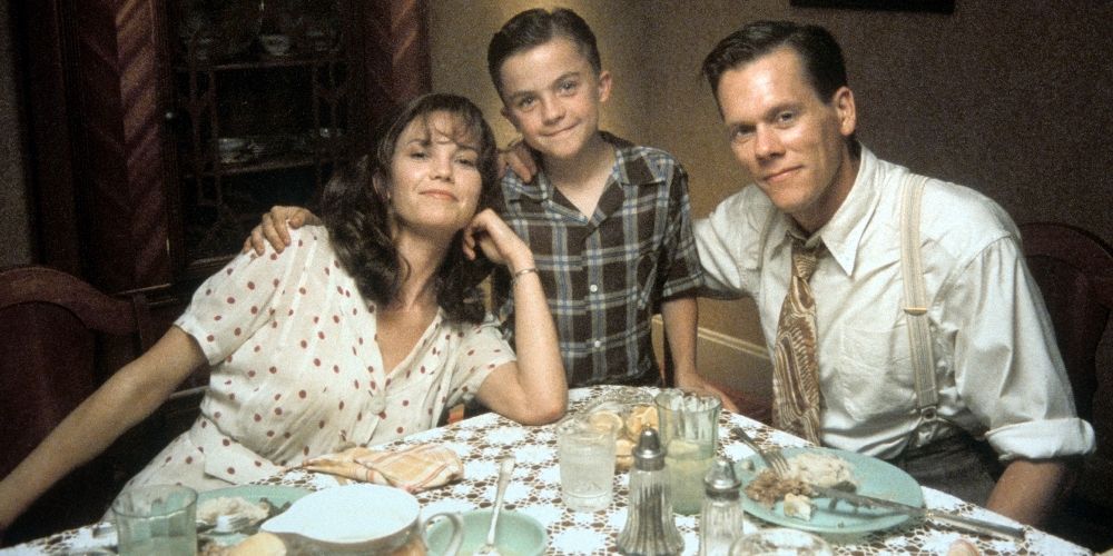 Skip and his parents pose for a family photo at the dinner table in My Dog Skip