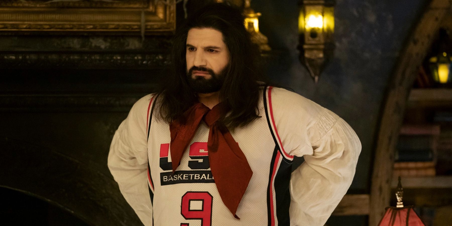 Nandor wearing a basketball jersey as he puts his arms on his waist in What We Do in the Shadows.