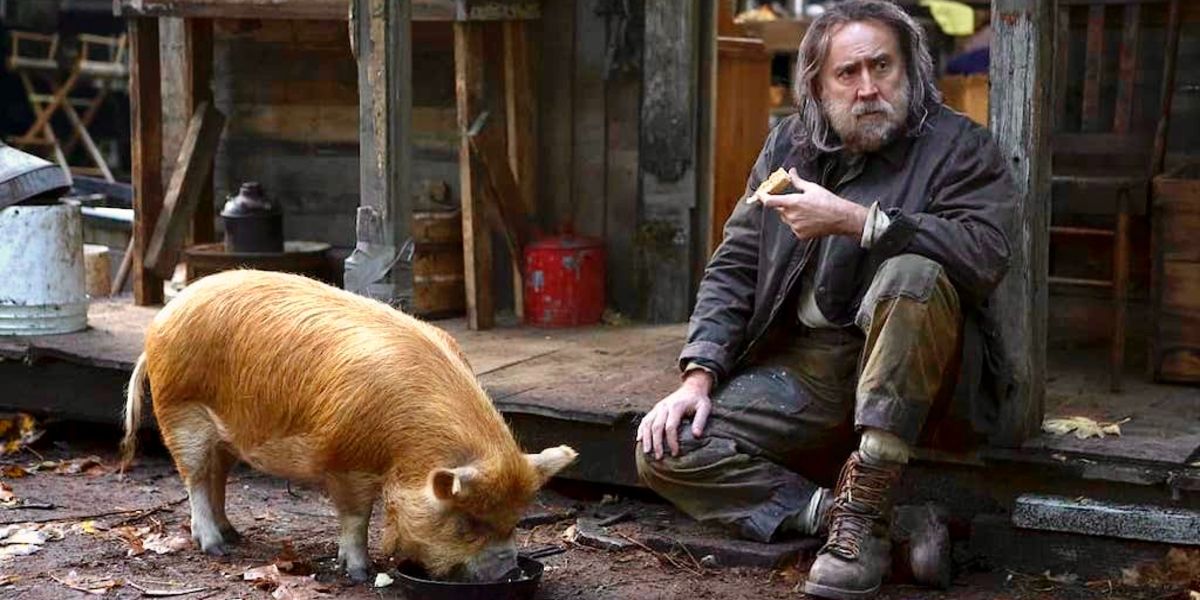 Rob shares a meal with his truffle-hunting pig in Pig (2021)
