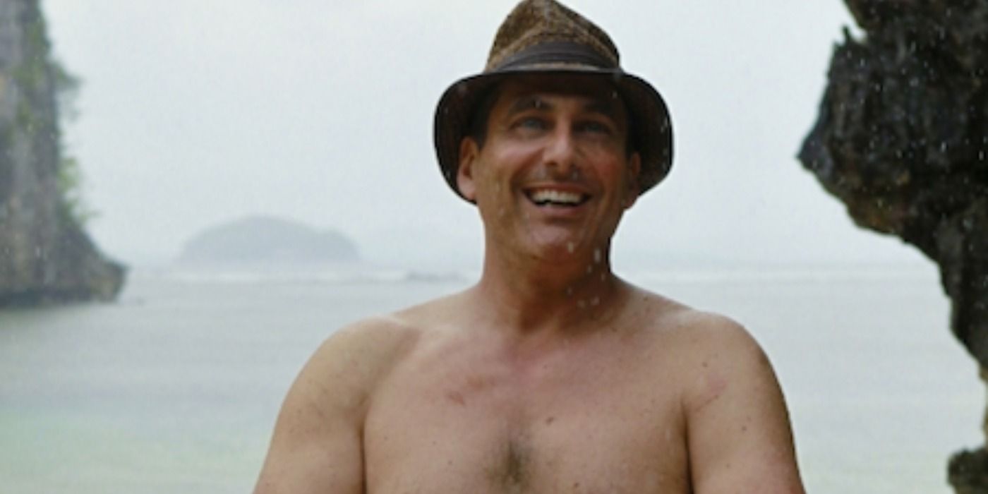 Jonathan Penner laughing in the rain on Survivor