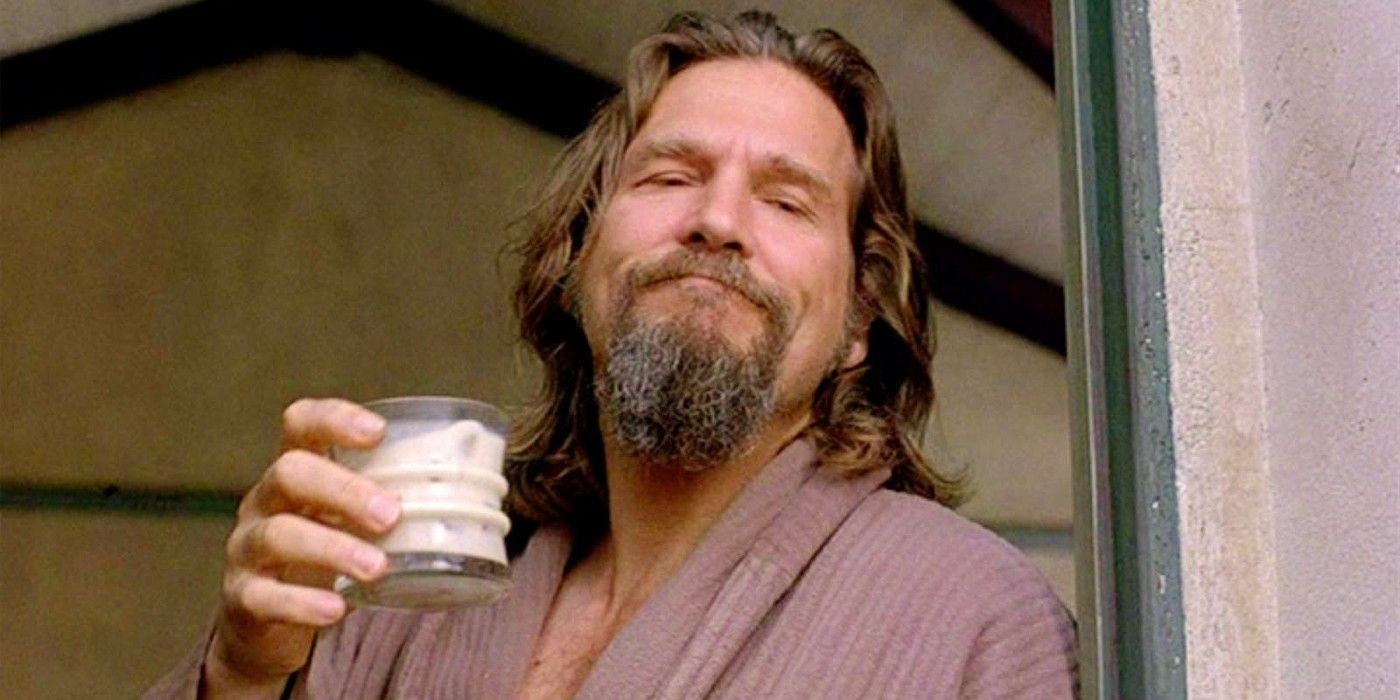 The Dude holding a glass and smiling in The Big Lebowski