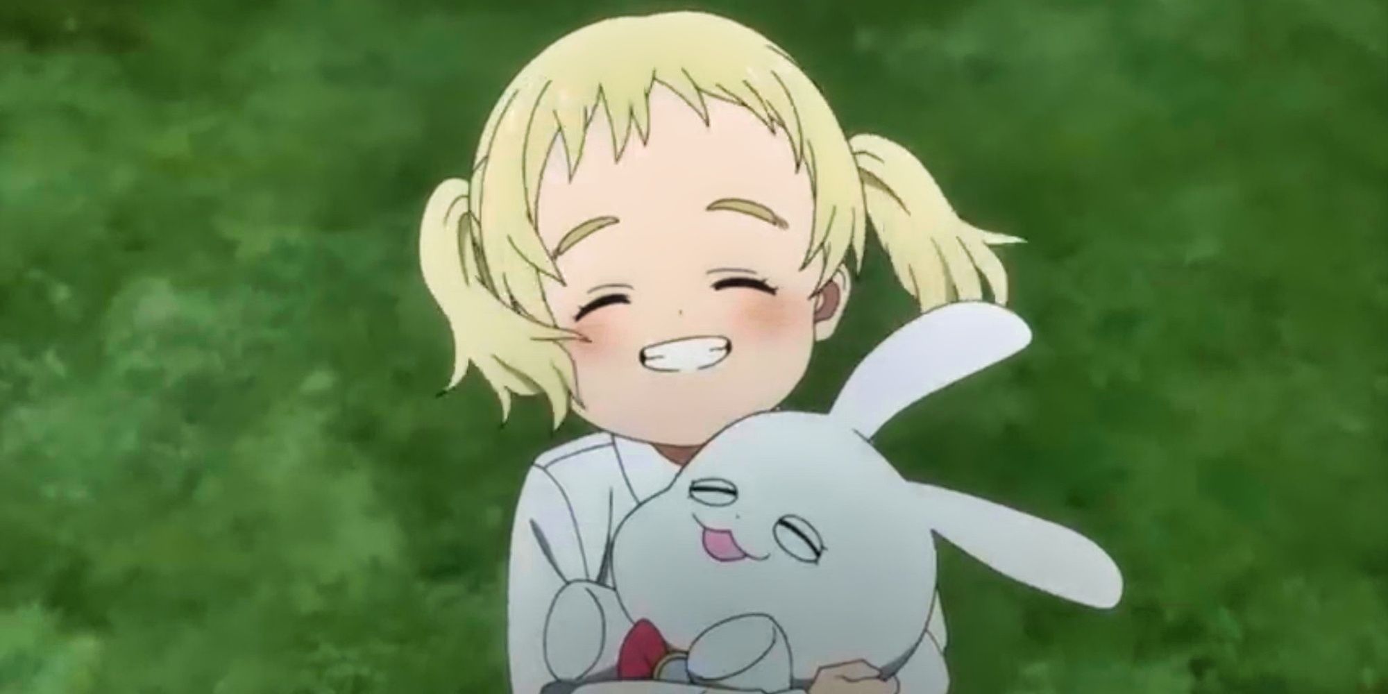 A young girl holds a bunny in The Promised Neverland