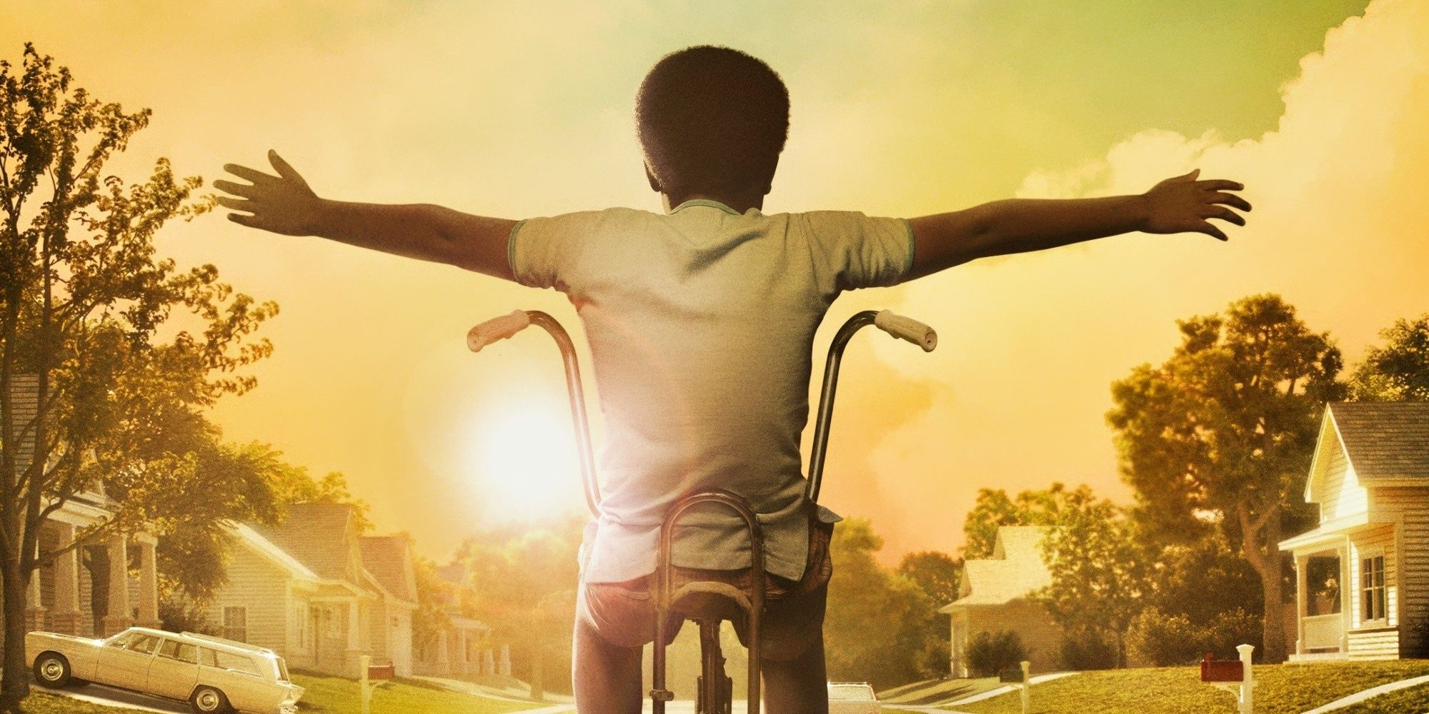 A boy spreading his arms while riding his bike in The Wonder Years reboot