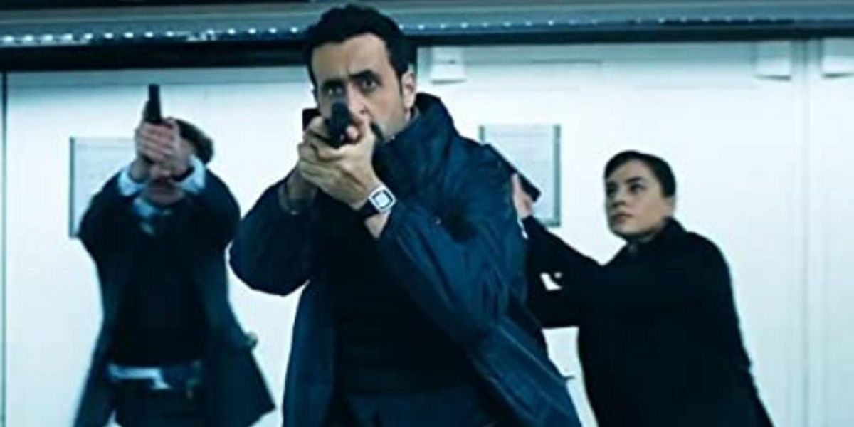 Delacroix aims his gun with other cops in Army of Thieves.