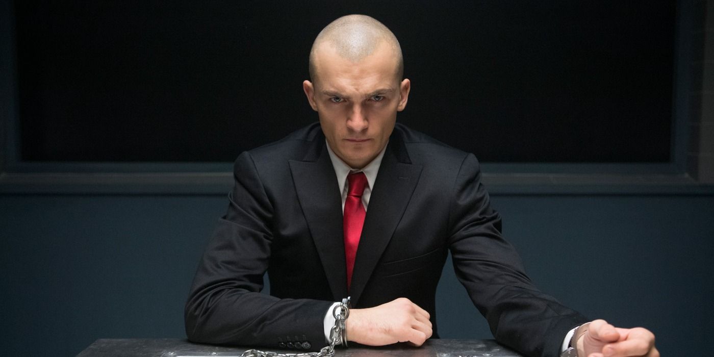 Agent 47 handcuffed to a table in Hitman Agent 47
