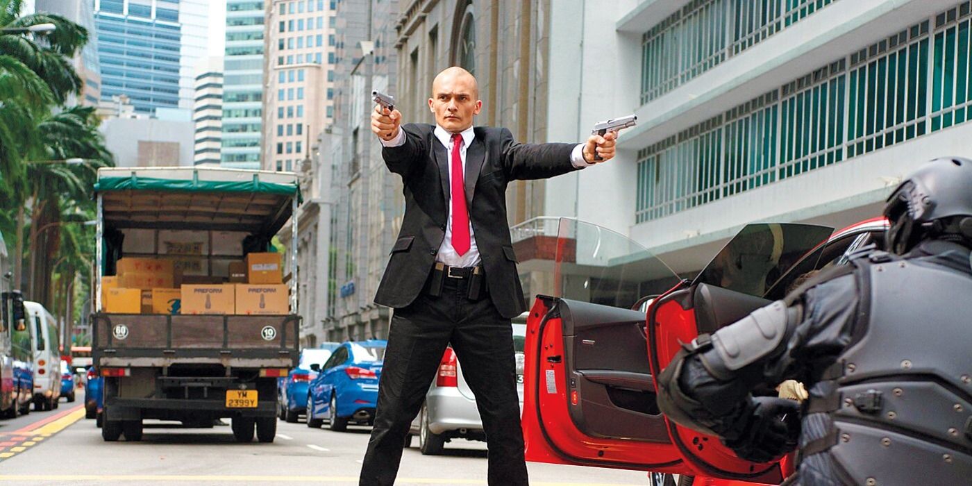 Agent 47 shooting people in the middle of the street in Hitman Agent 47