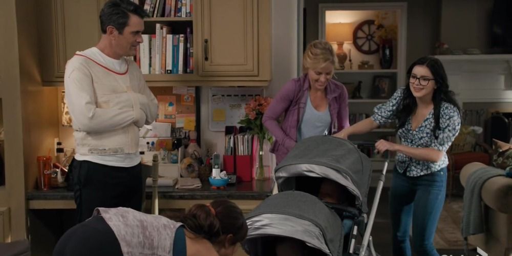 An image of Alex pushing a stroller and Haley looking at her twins in Modern Family