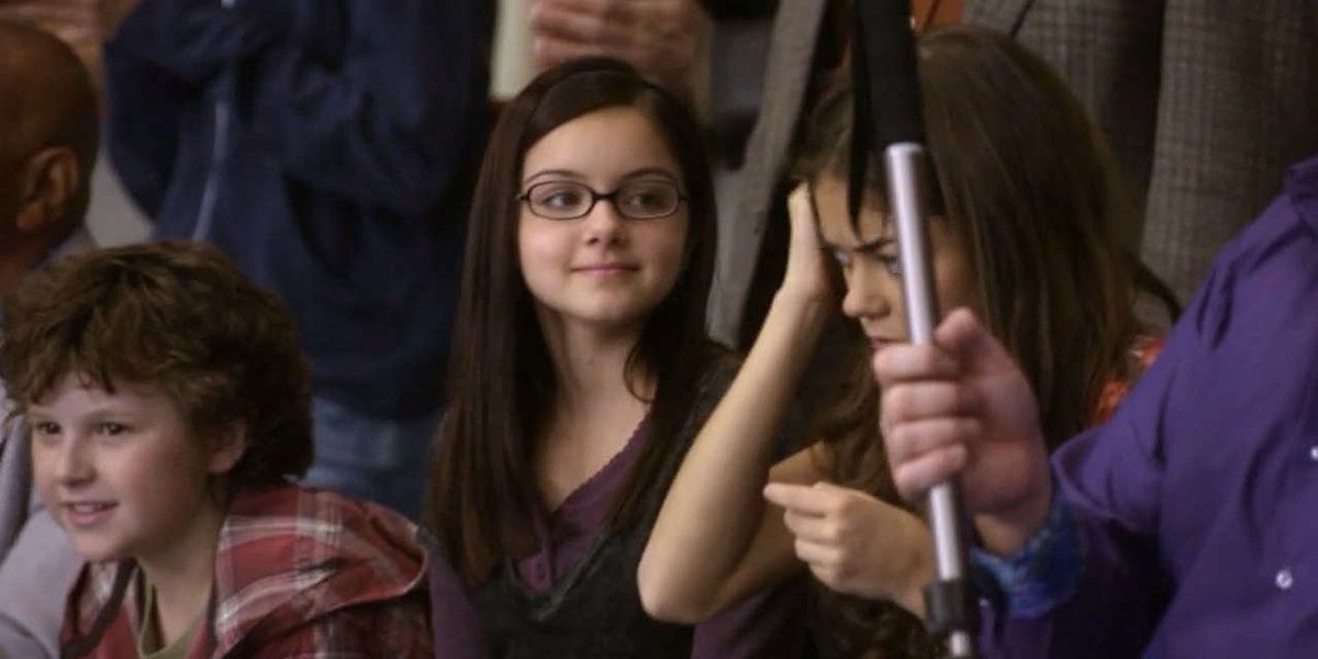 An image of Alex smiling at Haley rubbing the battery on her head in Modern Family
