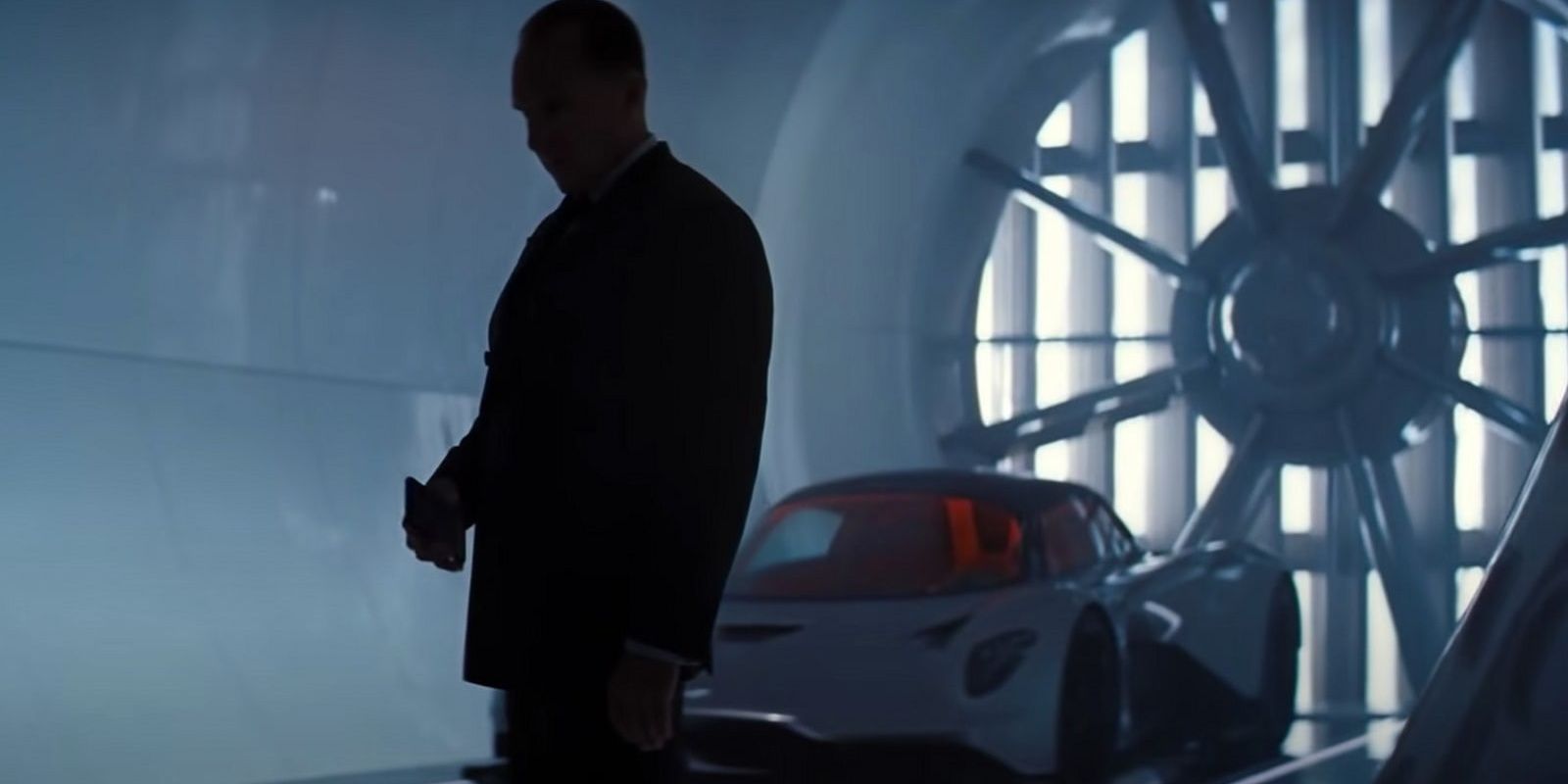 M stands in front of the Aston Martin Valhalla in No Time To Die