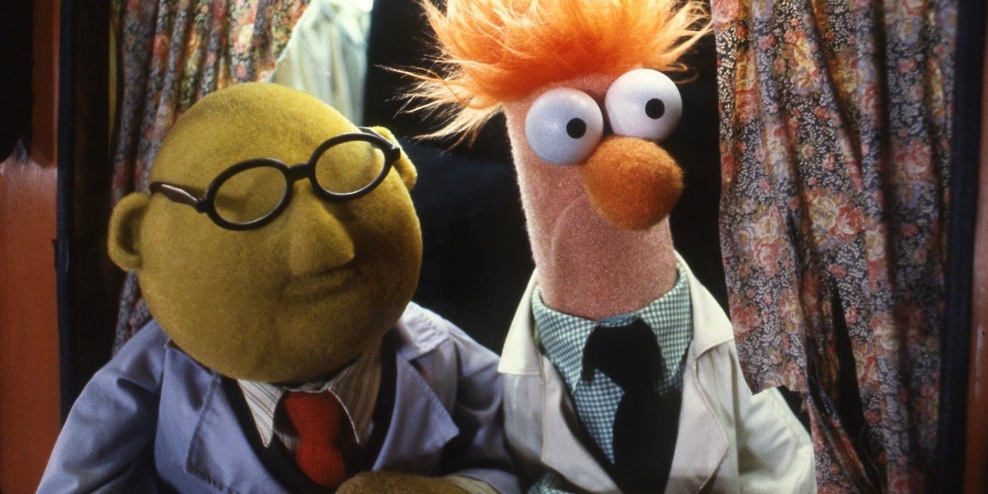 Beaker and Bunsen emerge from a curtain in the Muppets