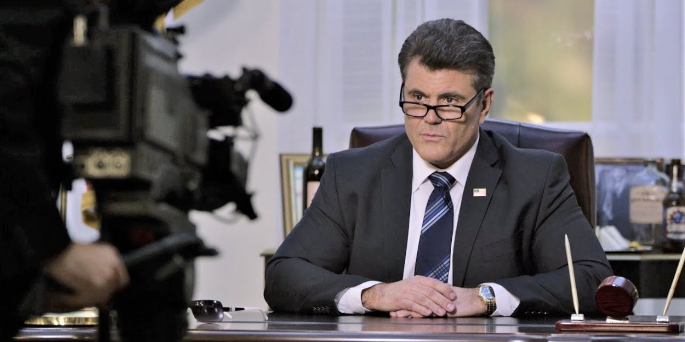 The president giving a speech as he sits behind his desk in the Oval Office in Bad President in Oats Studios.