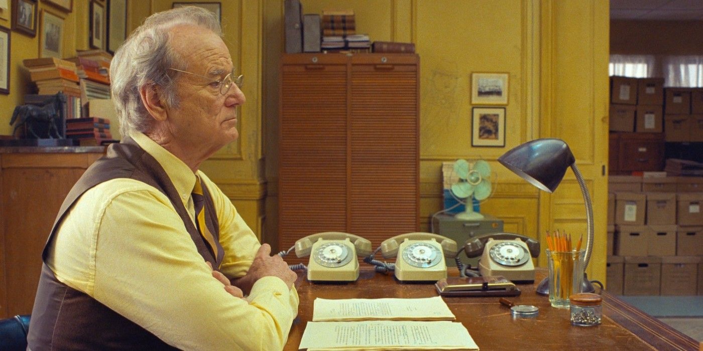 Bill Murray sits at his desk in The French Dispatch
