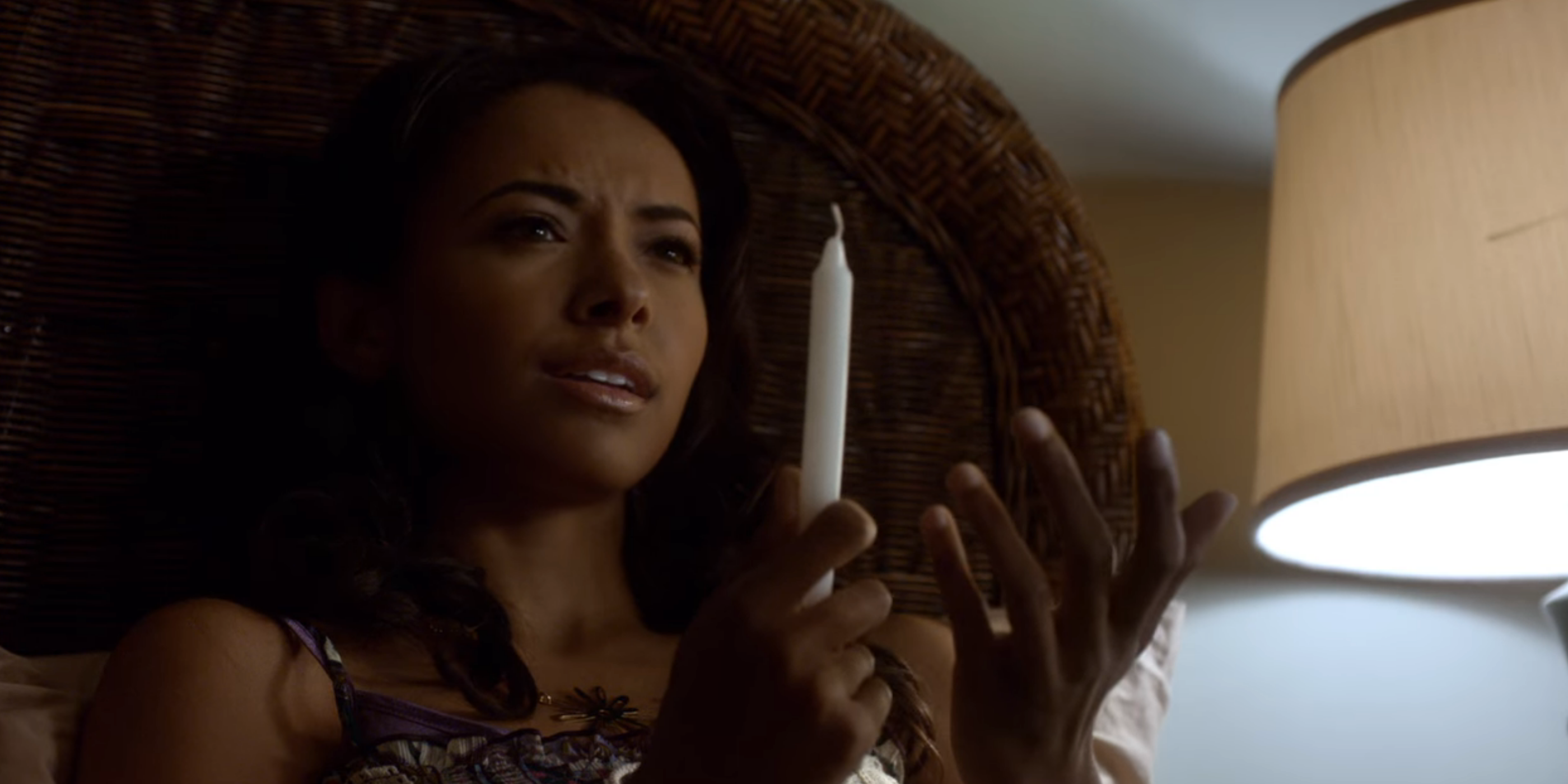 Bonnie holding a candle in The Vampire Diaries.