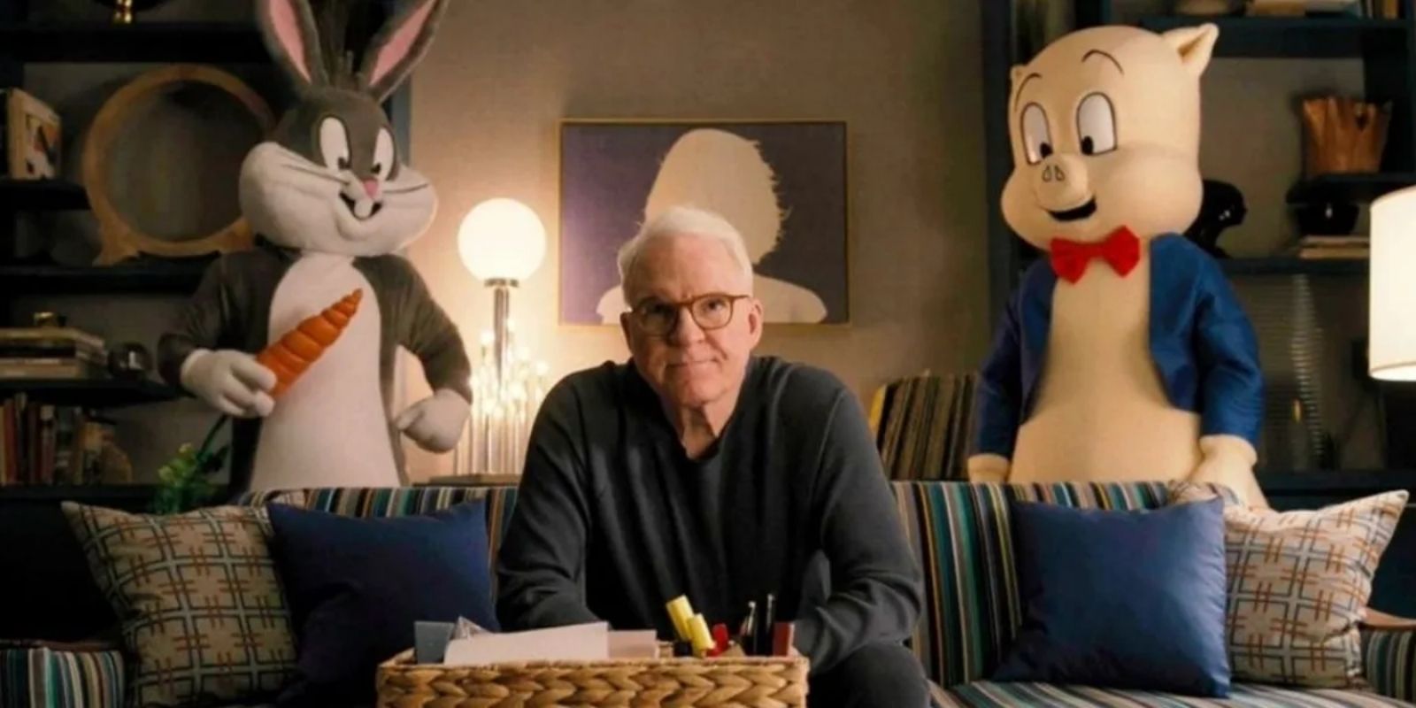 Bugs Bunny and Porky Pig stand behind Charles Haden Savages couch in Only Murders in the Building
