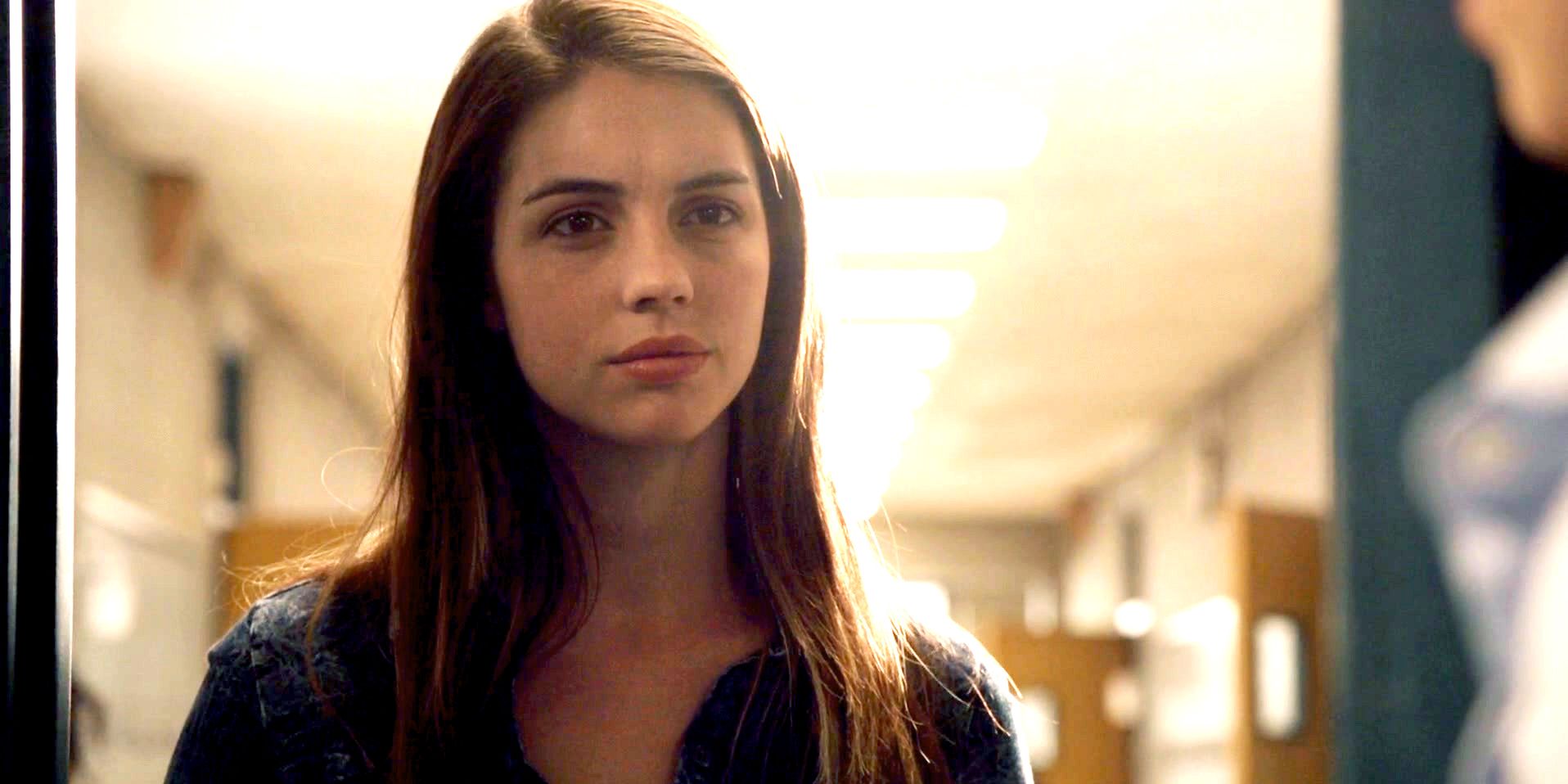 Cora standing in a doorway in Teen Wolf.