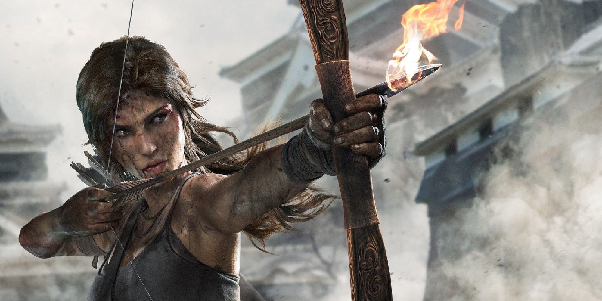 A dirt covered Lara Croft holding a bow and flaming arrow in Tomb Raider, aiming off camera