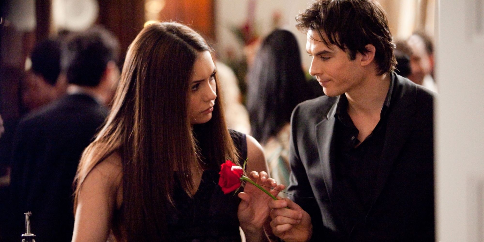 Damon gives Elena a rose in The Vampire Diaries.