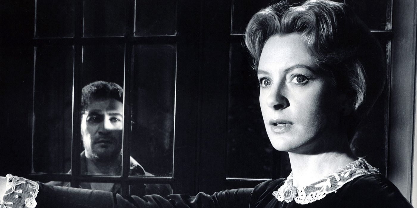 Deborah Kerr by a door with a man outside in The Innocents.