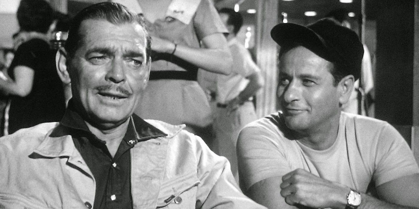 Eli Wallach and Clark Gable sitting at a table in The Misfits