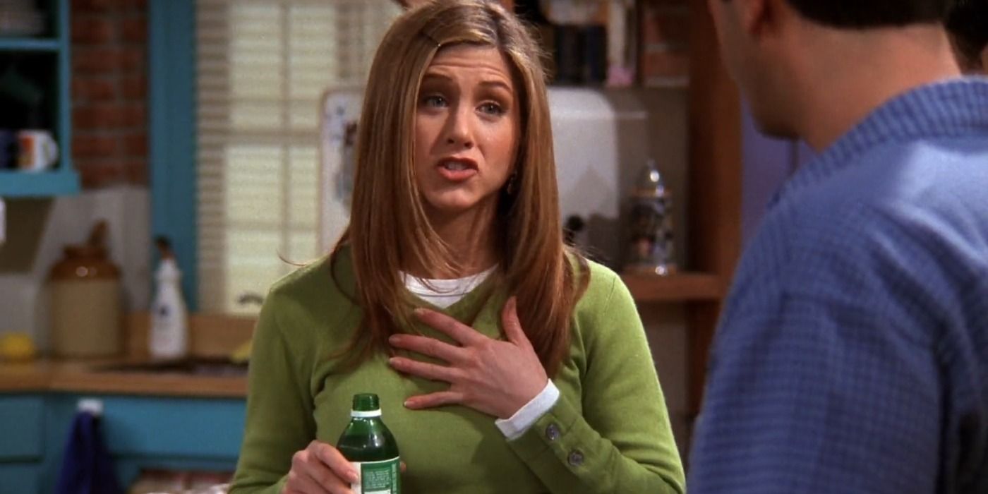 Rachel Green talking to Ross while sipping water at Monica's apartment in Friends