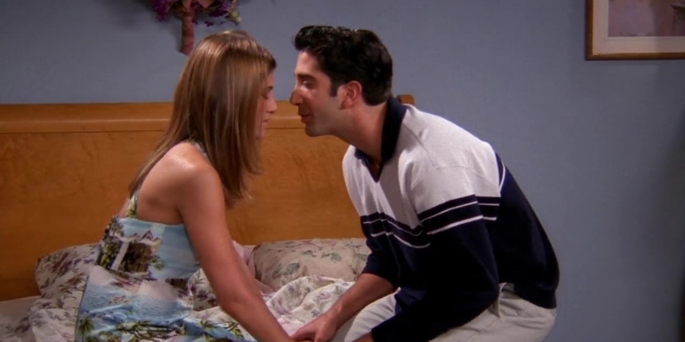 Rachel and Ross sitting in a bed on Friends