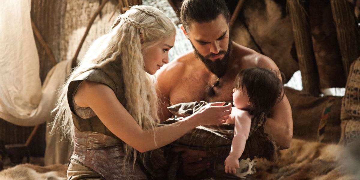 Daenerys and Drogo hold their newborn baby in Game of Thrones.