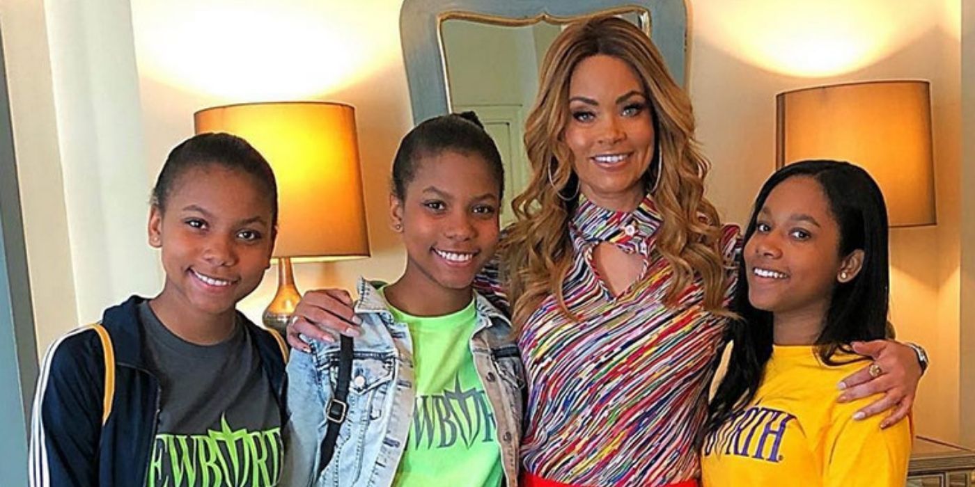 Gizelle Bryant and her daughters miling for a camera on RHOP