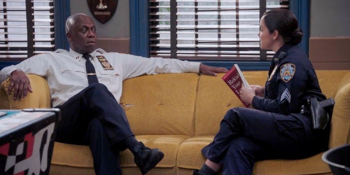 Holt and Amy sitting on a couch facing each other in Brooklyn Nine-Nine