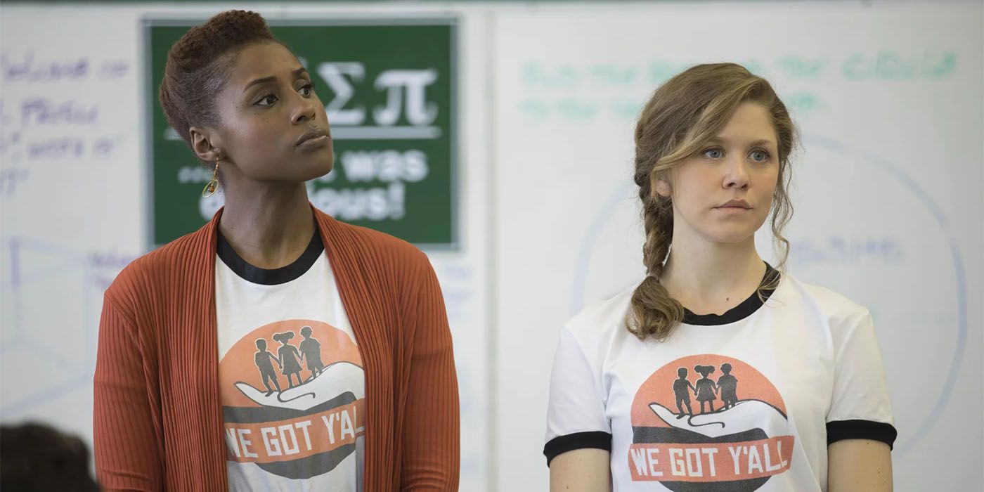 Issa standing next to a girl with a braid, both wearing matching T-shirts in Insecure