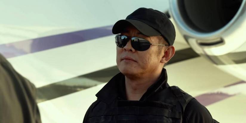 Jet Li in wears sunglasses and stands in front of a plane The Expendables 3
