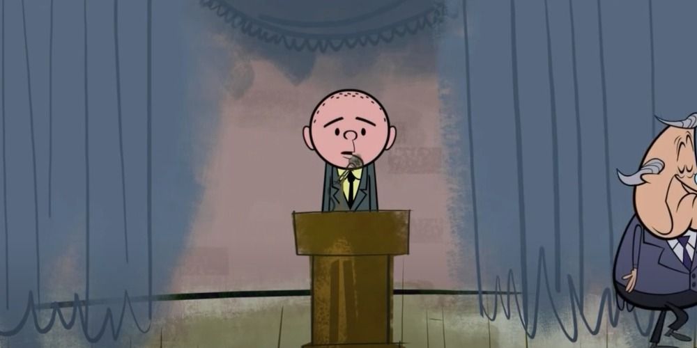 Karl standing at a podium on the Ricky Gervais Show