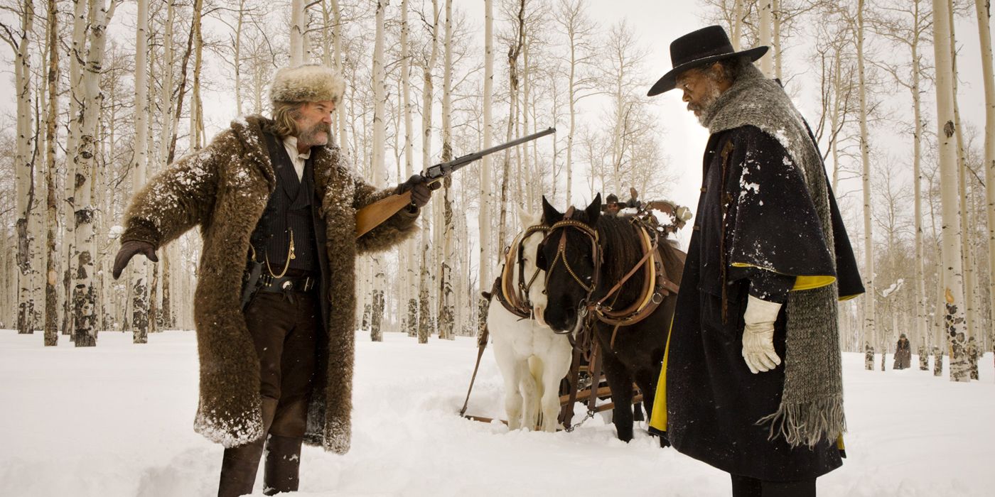 Kurt Russell pointing a gun at Sam Jackson in The Hateful Eight