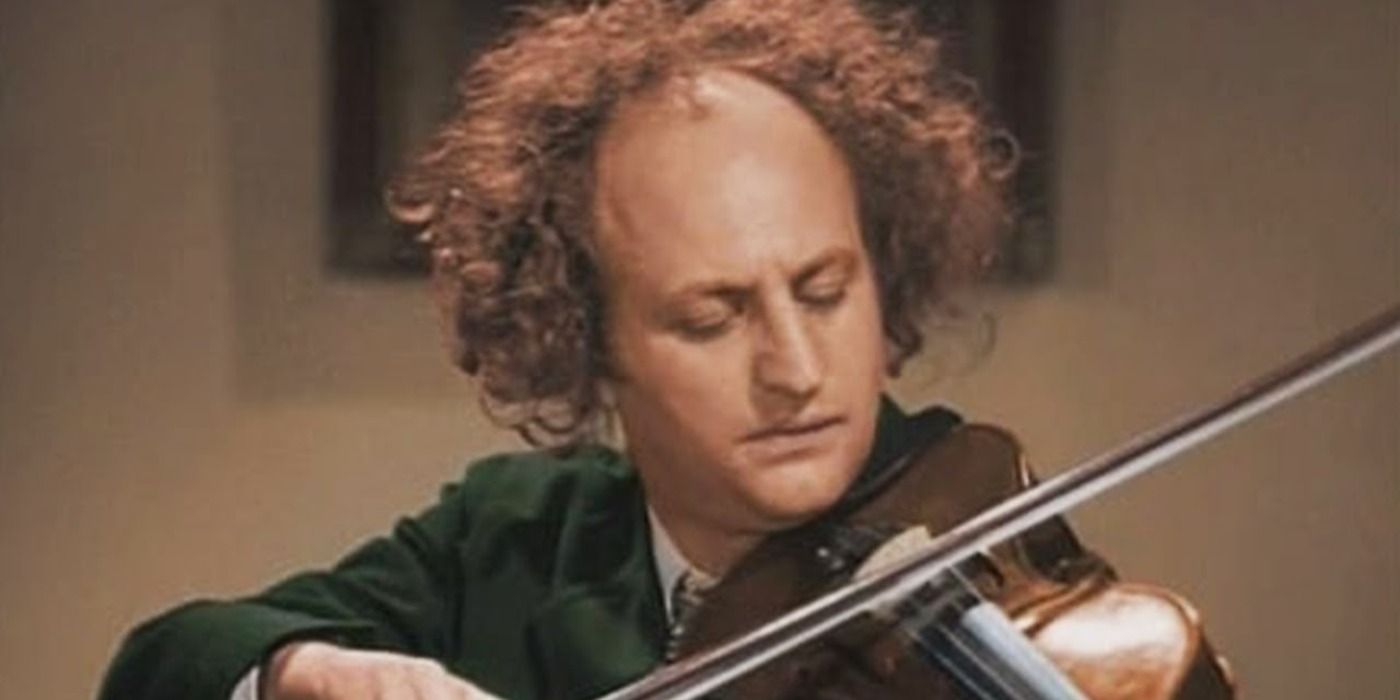 Larry playing the violin in a colorized still in Disorder in the Court