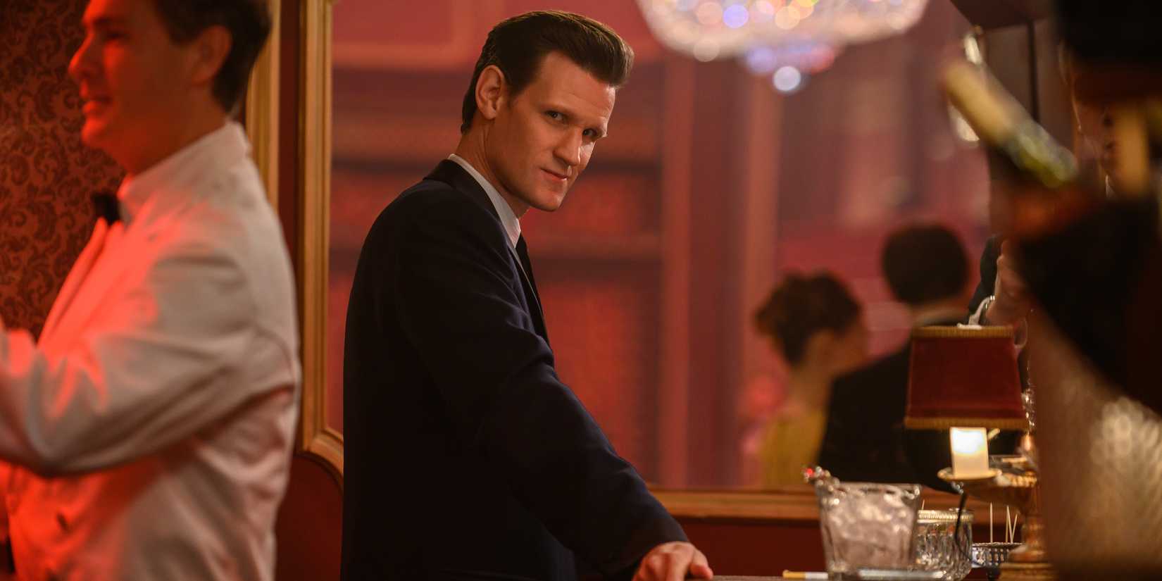 Matt Smith in Last Night in Soho smiles and looks at the camera.