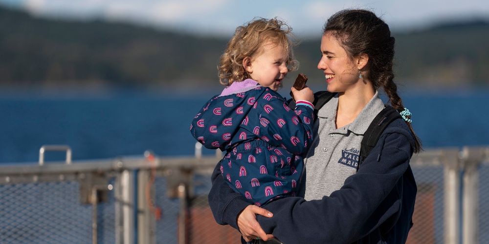 Alex holds Maddy at the ferry station on Netflix's Maid