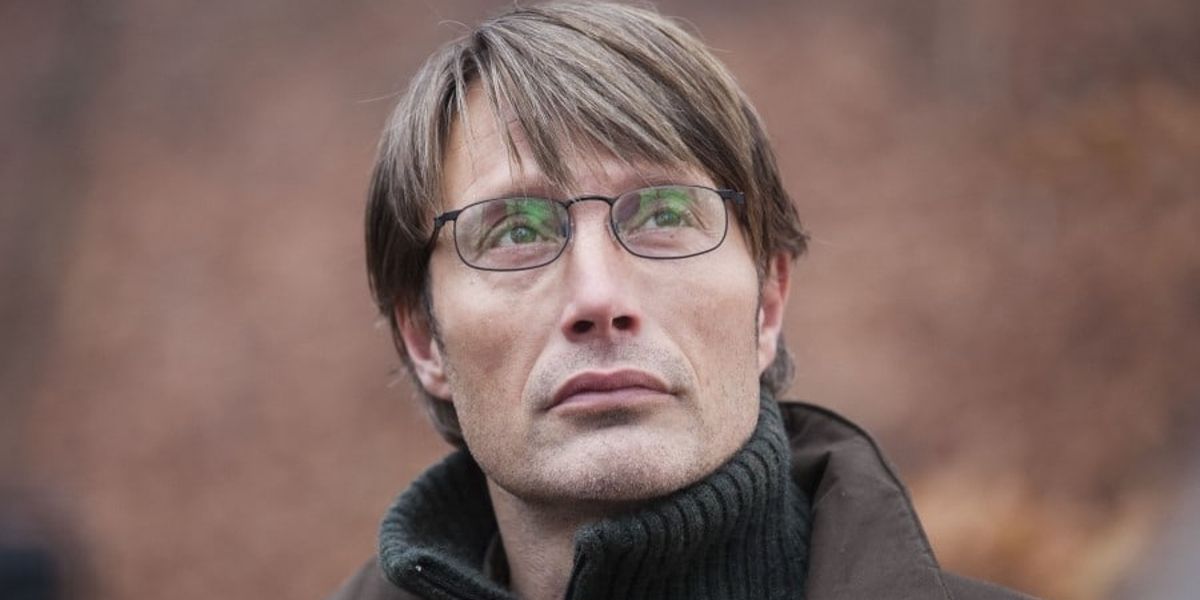 Lucas (Mads Mikkelsen) standing serenely in the woods in The Hunt