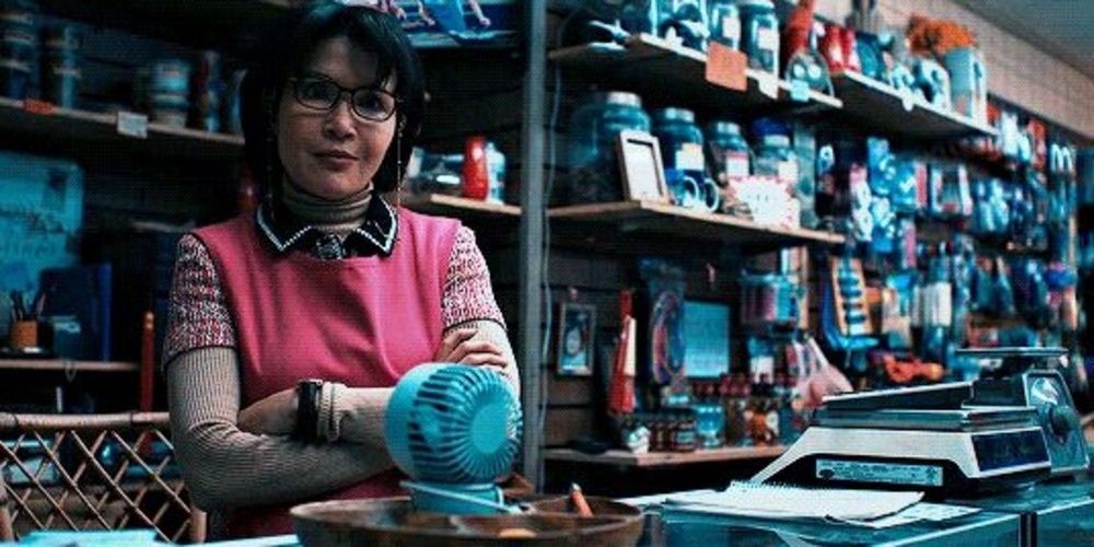 Mrs. Chen folds her arms in her store in Venom 2