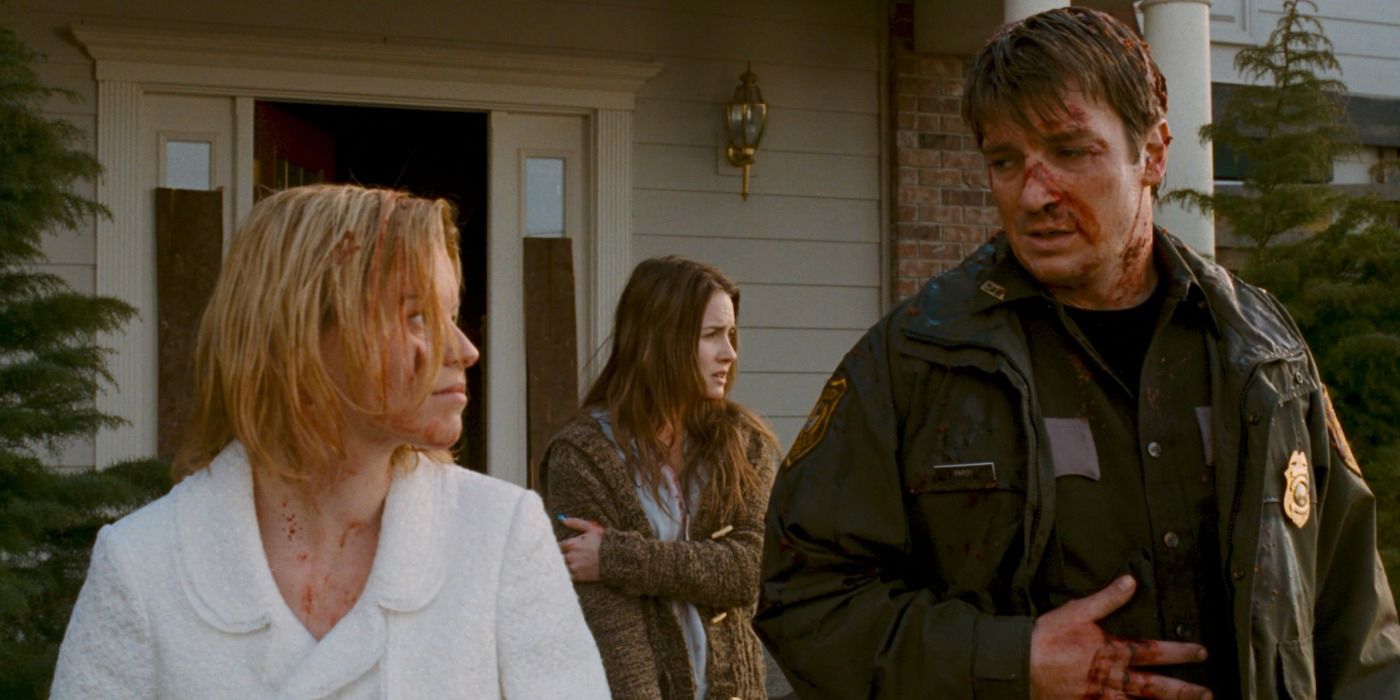 Nathan Fillion and Elizabeth Banks walking out of a house in Slither.
