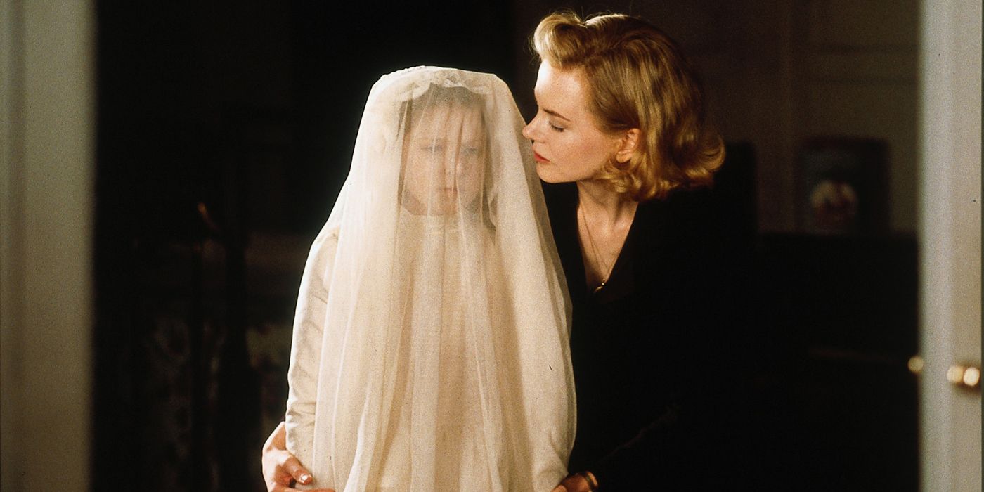 Nicole Kidman holding a cloaked child in The Others.
