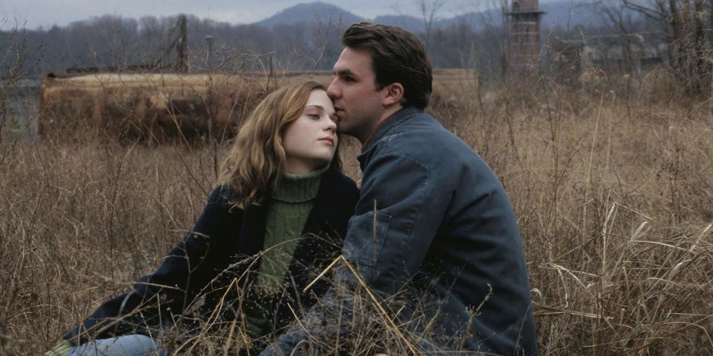 Noel and Paul sitting in a field in All the Real Girls.