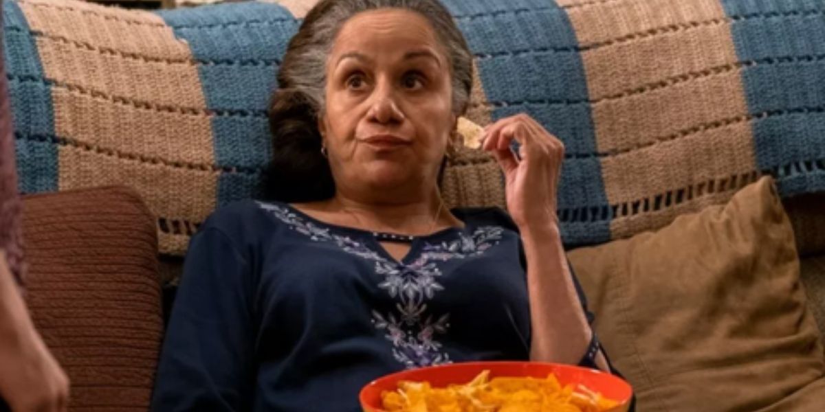 Abuelita eating chips on the coach in On My Block