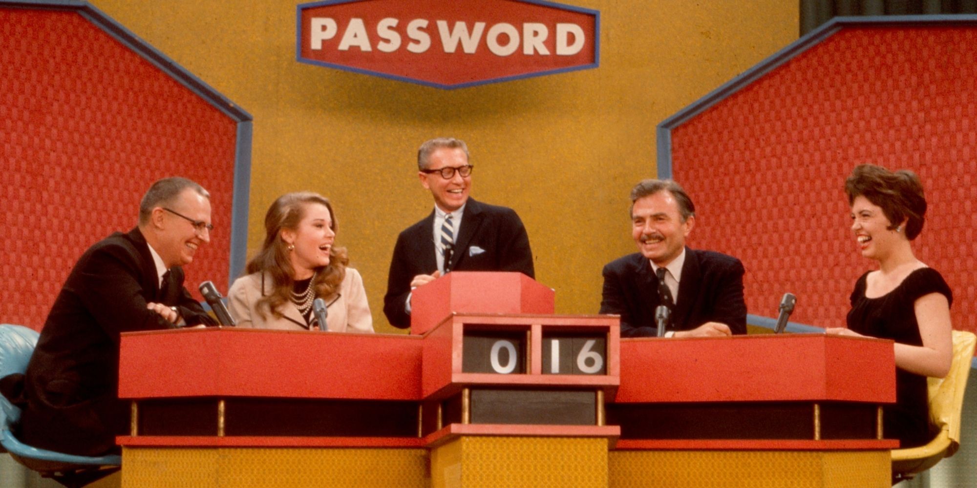 Four competitors in the Password game show grinning