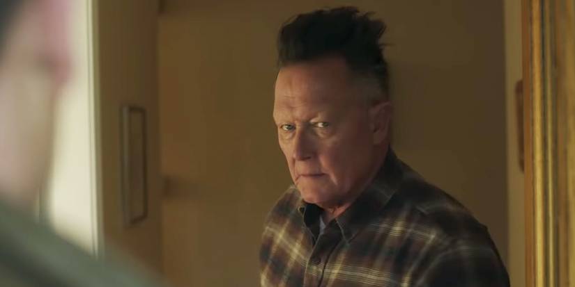 Auggie Smith looking annoyed in Peacemaker