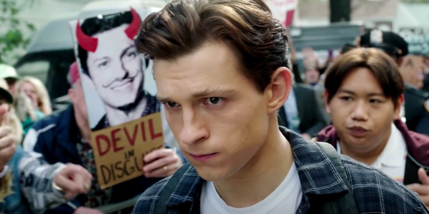 Peter Parker and Ned walk into school as protestors shout at them, holding up devil in disguise signs