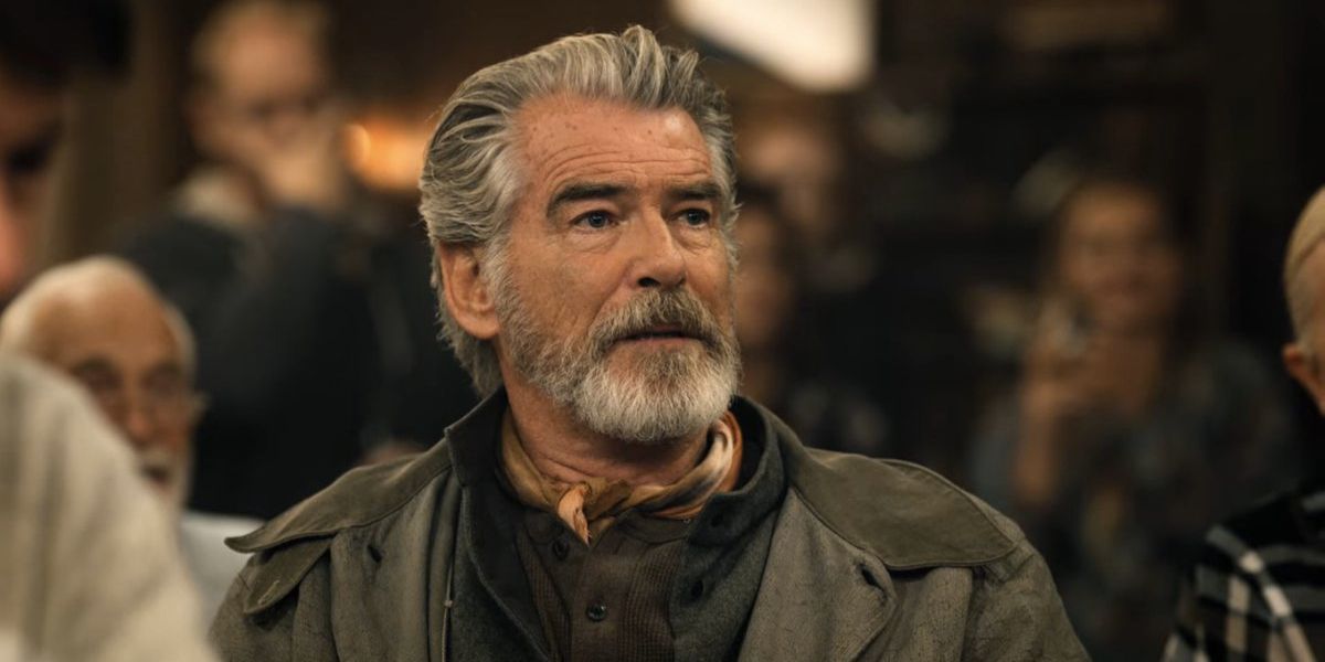 Pierce Brosnan looks out from a crowd in Eurovision.